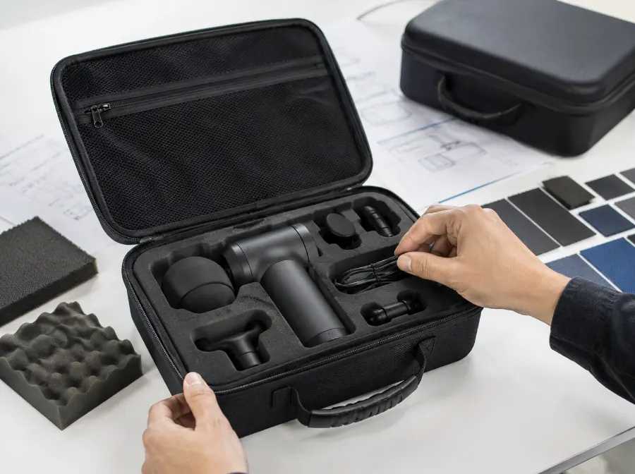 Custom EVA case for massage gun and accessories with precision-cut foam insert, mesh pocket, material samples and prototype fitting