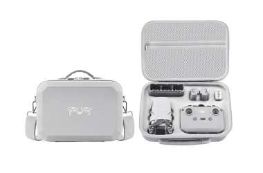 Two light gray custom EVA drone carrying cases: one closed featuring a handle and shoulder strap, and one open displaying a molded foam insert that precisely holds a drone, remote controller, and batteries.